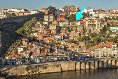 a city on a hill next to the water at Miradouro 25 - Porto centre - luxury epic views in Porto