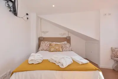 a bedroom with a bed with towels on it at Miradouro 25 - Porto centre - luxury epic views in Porto