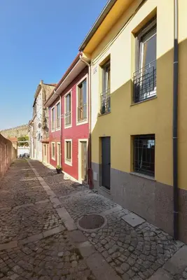 an empty street in a town with colorful buildings at Miradouro 25 - Porto centre - luxury epic views in Porto