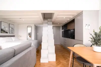 a living room with a bed and a dining room table at Limehome Porto Rua 31 de Janeiro in Porto