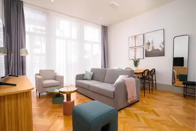 a living room with a couch and a table at Limehome Porto Rua 31 de Janeiro in Porto