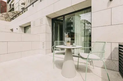 a white table and two chairs on a patio at Hotels 705 Porto Prime Home in Porto