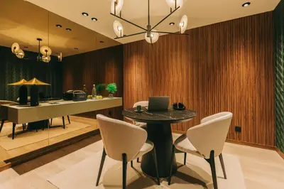 a dining room with a table with chairs and a laptop at Hotels 705 Porto Prime Home in Porto