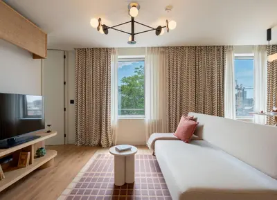 a living room with a bed and a tv at Hotels 705 Porto Prime Apartments in Porto