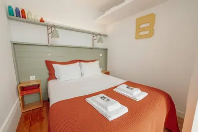 a bedroom with a bed with two towels on it at Downtown Bolhão by Hosty in Porto