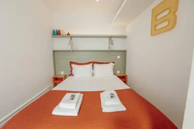 a bedroom with a bed with two towels on it at Downtown Bolhão by Hosty in Porto