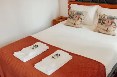 a bed with two white towels on top of it at Downtown Bolhão by Hosty in Porto
