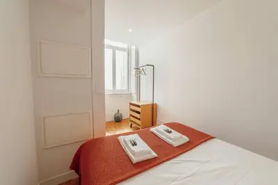 a bedroom with a bed with two towels on it at Downtown Bolhão by Hosty in Porto