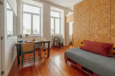 a room with a table and a bed and a dining room at Downtown Bolhão by Hosty in Porto
