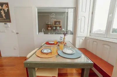 a table with plates of food on it in a room at Downtown Bolhão by Hosty in Porto