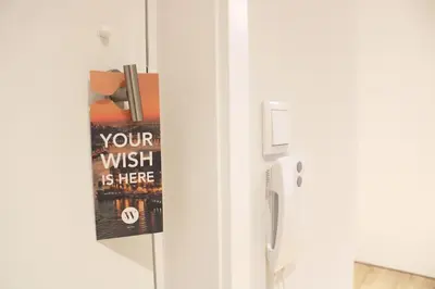 a door with a sign on it next to a refrigerator at Marquês City Center Flat in Porto