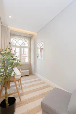 a living room with a table and a potted plant at Liiiving in Porto - Luxury Design Apartments in Porto