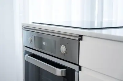 a black oven in a kitchen next to a counter at GuestReady - Little Johnny in Porto