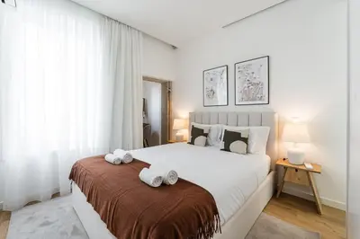 a bedroom with a large bed with towels on it at GuestReady - Little Johnny in Porto