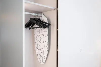 a closet with a white door and a closet organizer at GuestReady - Little Johnny in Porto