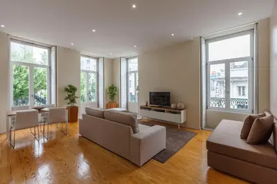 a living room with a couch and a tv at BO - Fernandes Tomás in Porto