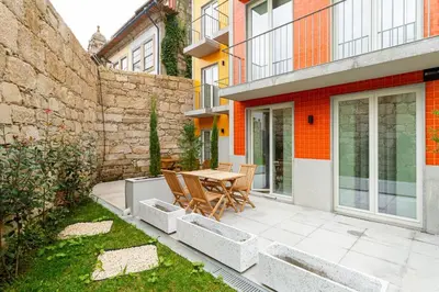 a patio with a table and chairs and a building at GuestReady - Dream Vitoria Apartment in Porto