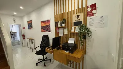 a room with a desk with a television on it at Owls Hostel Ribeiro in Porto