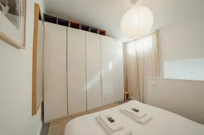 a white room with a bed and a mirror at Modern Studio by Hosty in Porto