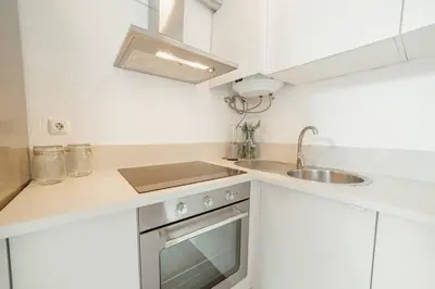 a small kitchen with a sink and a stove at Modern Studio by Hosty in Porto