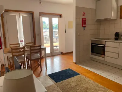 a kitchen and dining room with a table and chairs at Douro River Charming Flats in Porto