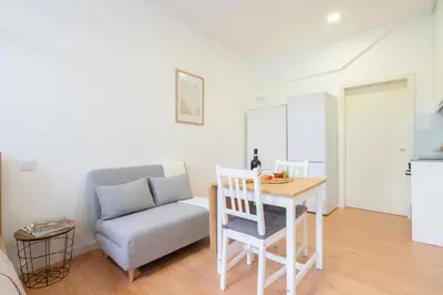 a living room with a couch and a table and a chair at Host Wise - Santa Catarina Cosy Downtown in Porto