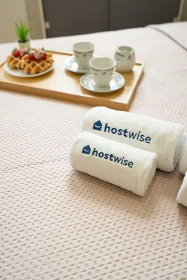 a bed with two towels and a tray of food at Host Wise - Santa Catarina Cosy Downtown in Porto