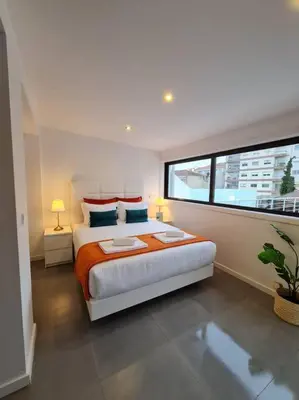 a bedroom with a large bed and a window at INSOLI I Porto by Apartments2Stay in Porto