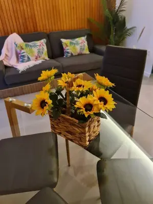 a basket of sunflowers on a table in a living room at INSOLI I Porto by Apartments2Stay in Porto