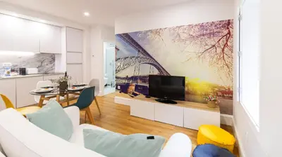a living room with a large painting on the wall at Porto River Flat w/ Patio by LovelyStay in Porto