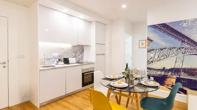 a kitchen and dining room with a table and chairs at Porto River Flat w/ Patio by LovelyStay in Porto