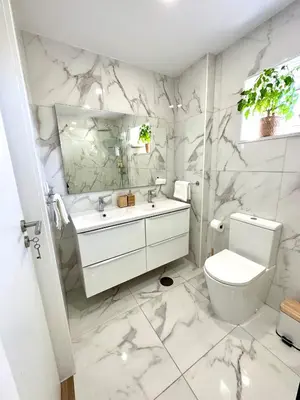 a white bathroom with a toilet and a sink at Fantástico T3 Porto - 6 Pessoas in Porto