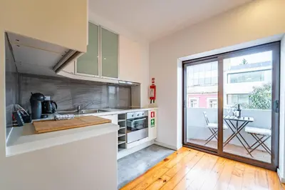a bathroom with a shower and a toilet and a sink at Brittos Lapa Apartment in Oporto City Center in Porto