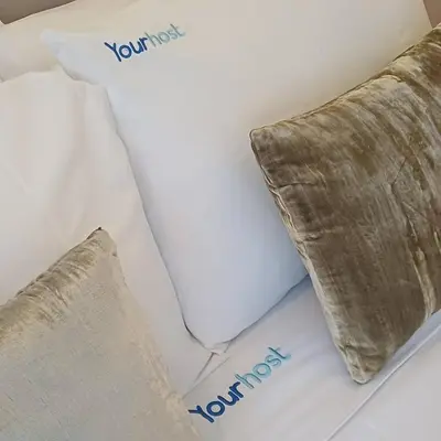 two pillows on a bed with the words your test your at Brittos Lapa Apartment in Oporto City Center in Porto