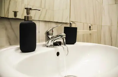 a bathroom sink with a soap dispenser on it at Oporto Central Flat - Downtown in Porto
