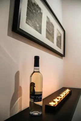 a bottle of wine sitting on a table with lights at Oporto Central Flat - Downtown in Porto