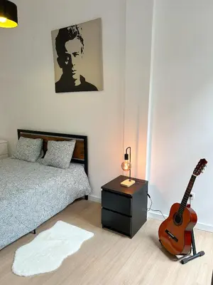 a bedroom with a bed and a guitar in it at Oporto Central Flat - Downtown in Porto