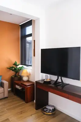 a living room with a large flat screen tv on a wall at Casas da Corujeira 2 in Porto