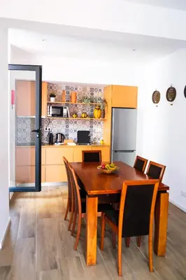 a kitchen and dining room with a wooden table and chairs at Casas da Corujeira 2 in Porto