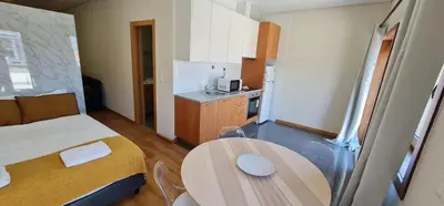 a room with a table and a bed and a kitchen at Tomas FLAT Front in Porto