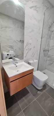 a bathroom with a sink and a toilet and a shower at Tomas FLAT Front in Porto