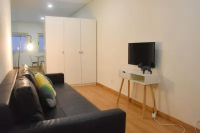 a living room with a couch and a tv at Tomas FLAT Front in Porto