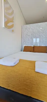a bedroom with a large bed with towels on it at Tomas FLAT Front in Porto