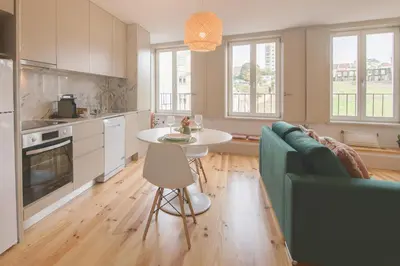 a kitchen and living room with a table and a couch at NEW - Bright Studio in Santa Catarina in Porto