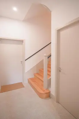 a staircase in a house with a white wall and a door at NEW - Bright Studio in Santa Catarina in Porto