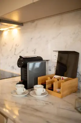 a counter with two coffee cups and a microwave at NEW - Bright Studio in Santa Catarina in Porto