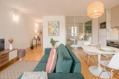 a living room with a green couch and a table at NEW - Bright Studio in Santa Catarina in Porto