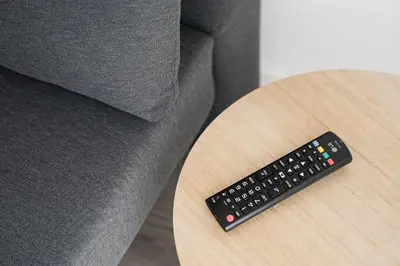 a remote control sitting on a table next to a couch at GuestReady - A sunny moment in Porto in Porto