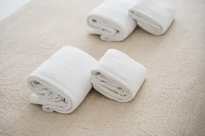 three white towels sitting on top of a floor at GuestReady - A sunny moment in Porto in Porto