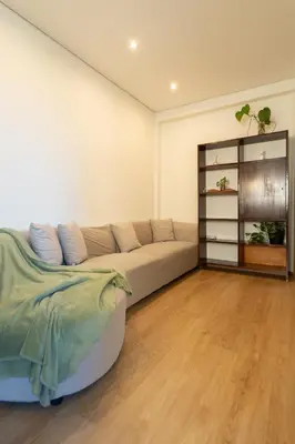 a living room with a couch and a book shelf at Jardim do Morro Apartment By Porto Stories in Vila Nova de Gaia